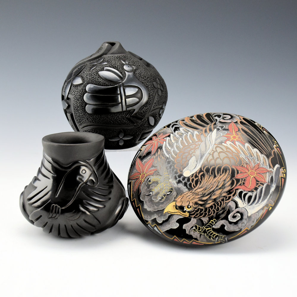 (top) Black bowl   (left) Christopher Youngblood  Carved jar with bird and cloud swirls 3.25 x 3  (right) Jennifer Tafoya Large seedpot with eagle and clouds 5 x 2.25