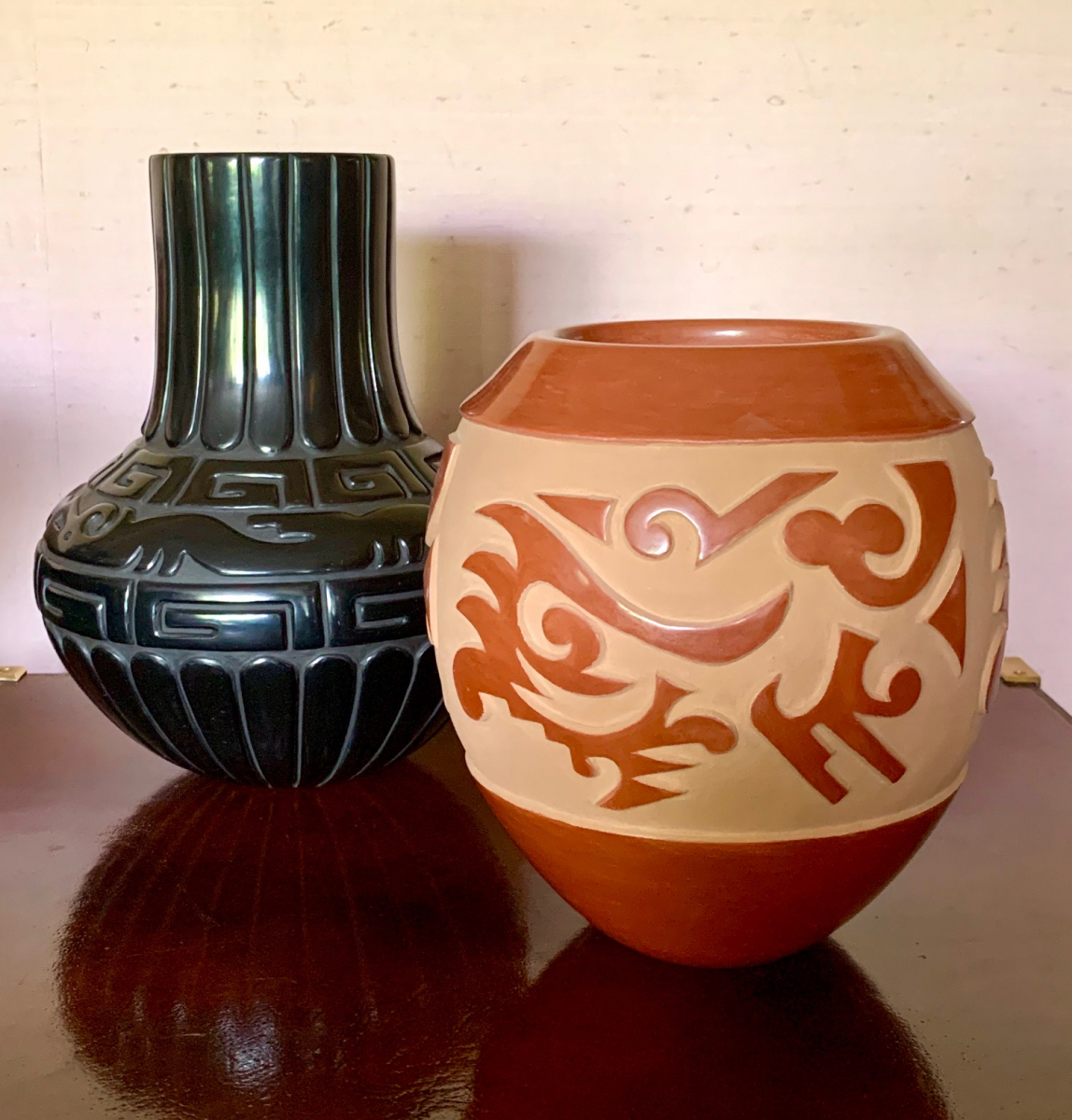 Black Avanyu Vase by Linda Tafoya Sanchez.  Reverse Redware Vase by James Ebelacker.