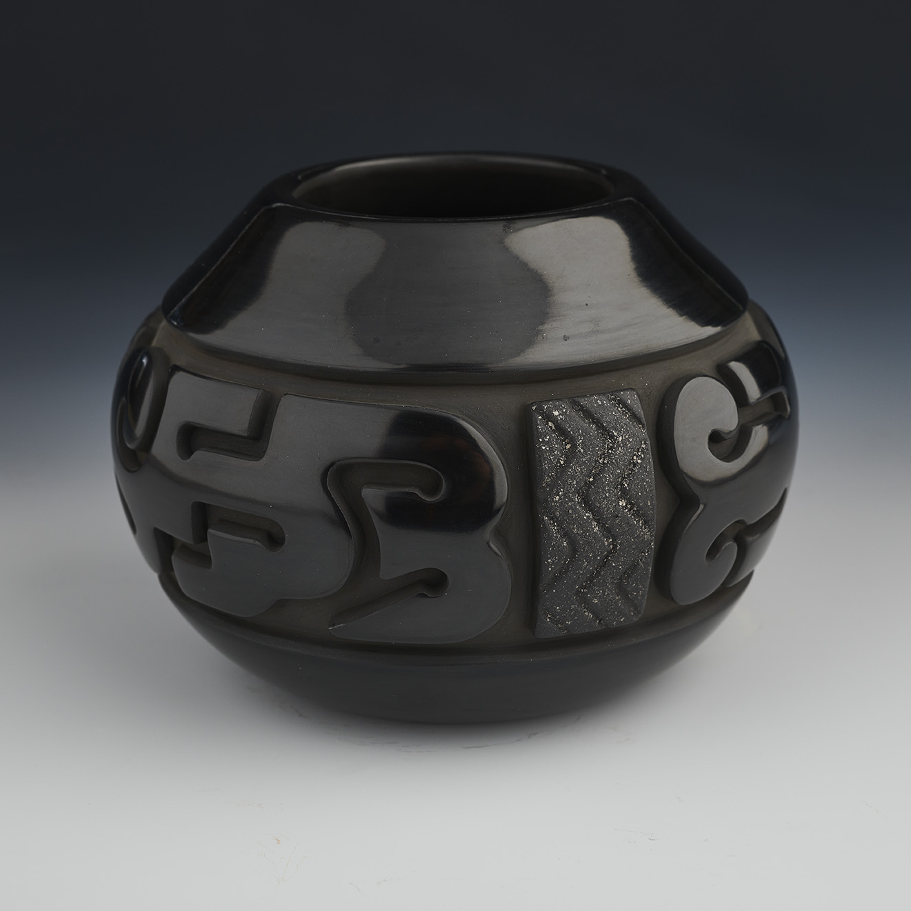 Hand-coiled, deep-carved black bowl
